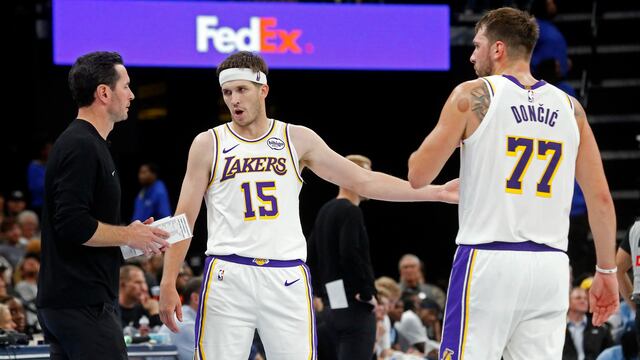 Oct 31, 2025; Memphis, Tennessee, USA; Los Angeles Lakers head coach JJ Redick talks with guard Austin Reaves (15) and guard Luka Doncic (77) during the fourth quarter against the Memphis Grizzlies at FedExForum. Mandatory Credit: Petre Thomas-Imagn Images