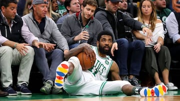 BOSTON, MASSACHUSETTS - MAY 06: Kyrie Irving #11 of the Boston Celtics falls into fans during the second half of Game 4 of the Eastern Conference Semifinals against the Milwaukee Bucks during the 2019 NBA Playoffs at TD Garden on May 06, 2019 in Boston, Massachusetts. The Bucks defeat the Celtics 113-101.   Maddie Meyer/Getty Images/AFP
 == FOR NEWSPAPERS, INTERNET, TELCOS &amp; TELEVISION USE ONLY ==