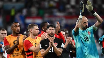 Canada's goalkeeper #18 Milan Borjan (R) applauds after Croatia won the Qatar 2022 World Cup Group F football match between Croatia and Canada at the Khalifa International Stadium in Doha on November 27, 2022. (Photo by Anne-Christine POUJOULAT / AFP)