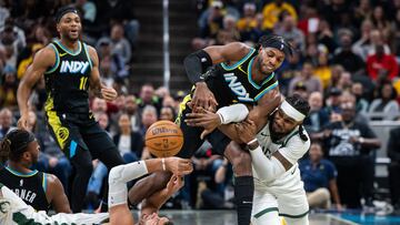 Nov 9, 2023; Indianapolis, Indiana, USA; Indiana Pacers guard Buddy Hield (7) and Milwaukee Bucks forward Jae Crowder (99) fight for a loose ball in the first half at Gainbridge Fieldhouse. Mandatory Credit: Trevor Ruszkowski-USA TODAY Sports