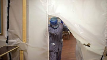 (FILES) In this file photo a healthcare worker walks through a sealed off Covid patient area in the ER at Oakbend Medical Center in Richmond, Texas, on July 15, 2020. - The United States announced an emergency authorization to use blood plasma from recove