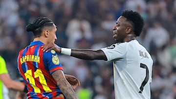 Soccer Football - Spanish Super Cup - Final - FC Barcelona v Real Madrid - King Abdullah Sports City Stadium, Jeddah, Saudi Arabia - January 11, 2026 FC Barcelona's Raphinha with Real Madrid's Vinicius Junior REUTERS/Stringer