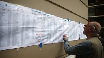 BUENOS AIRES, ARGENTINA - OCTOBER 22: A voter looks for his name in a registration list outside the polling station during the general elections at UTN University on October 22, 2023 in Buenos Aires, Argentina. The presidential election to succeed Alberto Fernandez comes as Argentinians have been hard hit by an annual 124% inflation and over 40% of the population is considered to be living in poverty. (Photo by Tomas Cuesta/Getty Images)