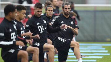 Bayern's Javi Martinez, right, stretches besides team mates during a training session in Munich, Germany, Friday, Sept. 11, 2020. The German Bundesliga starts next Friday, Sept. 18, 2020. (AP Photo/Matthias Schrader)
