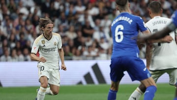 Real Madrid's Croatian midfielder #10 Luka Modric runs with the ball during the Spanish Liga football match between Real Madrid CF and Getafe CF at the Santiago Bernabeu stadium in Madrid on September 2, 2023. (Photo by Thomas COEX / AFP)