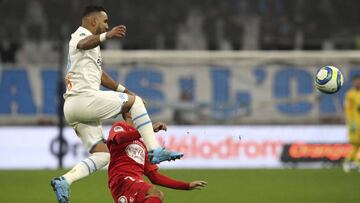 Marseille's Dimitri Payet, left, and Brest's Haris Belkebla challenge for the ball during the French League One soccer match between Marseille and Brest at the Velodrome stadium in Marseille, southern France, Friday, Nov. 29, 2019. (AP Photo/Dan