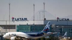 (FILES) In this file photo taken on May 26, 2020, a Latam airlines plane sits on the tarmac at Santiago International Airport, in Santiago, during the new coronavirus, COVID-19, pandemic. - The Chilean-Brazilian airline LATAM announced on June 17 that its subsidiary in Argentina will cease operations for an indefinite period, because in a pandemic scenario its operations are not viable. (Photo by Martin BERNETTI / AFP)