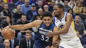 Mar 29, 2019; Minneapolis, MN, USA; Minnesota Timberwolves center Karl-Anthony Towns (32) drives to the basket past Golden State Warriors forward Kevin Durant (35) in the second half at Target Center. Mandatory Credit: Jesse Johnson-USA TODAY Sports