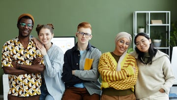 Portrait of diverse creative team in office all looking at camera with cheerful smiles