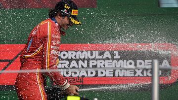 Ferrari's Spanish driver Carlos Sainz celebrates with champagne in the podium after winning the Mexico City Formula One Grand Prix at the Hermanos Rodriguez racetrack, in Mexico City on October 27, 2024. (Photo by Alfredo ESTRELLA / AFP)