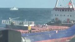 A still image from a video, released by Russia's Defence Ministry, shows what it said to be crew members kneeling down on the deck during an operation held by Russian navy officers to board the Palau-flagged Sukru Okan vessel with the help of a Ka-29 military helicopter in the Black Sea on August 13, 2023, in this image taken from footage published August 15, 2023. Russian Defence Ministry/Handout via REUTERS ATTENTION EDITORS - THIS IMAGE WAS PROVIDED BY A THIRD PARTY. NO RESALES. NO ARCHIVES. MANDATORY CREDIT. WATERMARK FROM SOURCE.