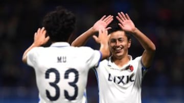 SUITA, JAPAN - DECEMBER 14: Yuma Suzuki of Kashima Antlers celebrates with Mu Kanazaki of Kashima Antlers after scoring his sides third goal during the FIFA Club World Cup Semi Final match between Atletico Nacional and Kashima Antlers at Suita City Footba