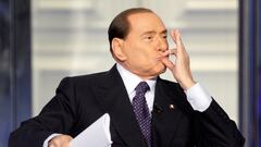 FILE PHOTO: Italy's former Prime Minister Silvio Berlusconi gestures as he appears as a guest on the RAI television show Porta a Porta (Door to Door) in Rome, Italy, January 9, 2013.  REUTERS/Remo Casilli/File Photo