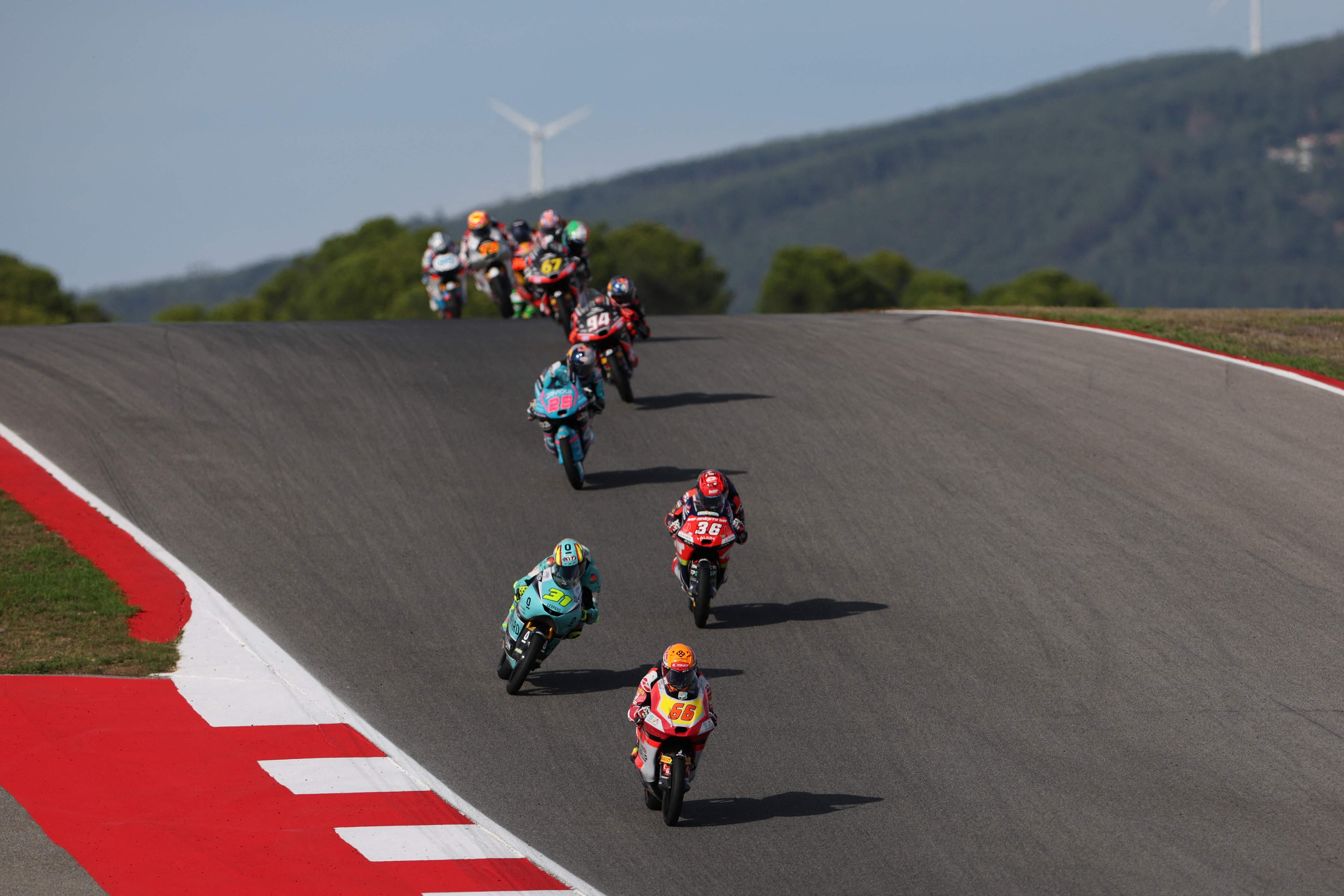 Riders compete during the Moto3 race of the Portuguese Grand Prix at the Algarve International Circuit in Portimao on November 9, 2025. (Photo by PATRICIA DE MELO MOREIRA / AFP)