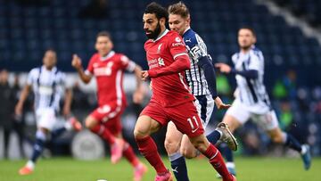 Liverpool's Egyptian midfielder Mohamed Salah (C) runs with the ball during the English Premier League football match between West Bromwich Albion and Liverpool at The Hawthorns stadium in West Bromwich, central England, on May 16, 2021. (Photo by La