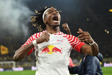 Leipzig's French defender #02 Mohamed Simakan celebrates after his team scored the 1:3 during the German first division Bundesliga football match between BVB Borussia Dortmund and RB leipzig in Dortmund, western Germany on December 9, 2023. (Photo by INA FASSBENDER / AFP) / DFL REGULATIONS PROHIBIT ANY USE OF PHOTOGRAPHS AS IMAGE SEQUENCES AND/OR QUASI-VIDEO