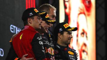 ABU DHABI, UNITED ARAB EMIRATES - NOVEMBER 20: Race winner Max Verstappen of the Netherlands and Oracle Red Bull Racing, second placed Charles Leclerc of Monaco and Ferrari, Olaf Janssen, Red Bull Racing Team Member and Third placed Sergio Perez of Mexico and Oracle Red Bull Racing celebrate on the podium during the F1 Grand Prix of Abu Dhabi at Yas Marina Circuit on November 20, 2022 in Abu Dhabi, United Arab Emirates. (Photo by Joe Portlock - Formula 1/Formula 1 via Getty Images)