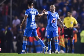 Cruz Azul's midfielder #15 Jose Rivero celebrates with teammate midfielder #19 Carlos Rodriguez after scoring his team's first goal during the Liga MX Apertura football league match between Cruz Azul and Guadalajara Chivas at the Ciudad de los Deportes stadium in Mexico City on September 21, 2024 (Photo by Rodrigo Oropeza / AFP)