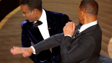 FILE PHOTO: Will Smith (R) hits Chris Rock as Rock spoke on stage during the 94th Academy Awards in Hollywood, Los Angeles, California, U.S., March 27, 2022. REUTERS/Brian Snyder/File Photo