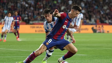 Barcelona's Polish forward #09 Robert Lewandowski vies with Real Sociedad's French defender #24 Robin Le Normand during the Spanish league football match between FC Barcelona and Real Sociedad at the Estadi Olimpic Lluis Companys in Barcelona on May 13, 2024. (Photo by LLUIS GENE / AFP)