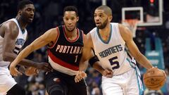 Jan 18, 2017; Charlotte, NC, USA; Charlotte Hornets guard forward Nicolas Batum (5) drives past Portland Trail Blazers guard forward Evan Turner (1) during the second half of the game at the Spectrum Center. Hornets win 107-85. Mandatory Credit: Sam Sharpe-USA TODAY Sports