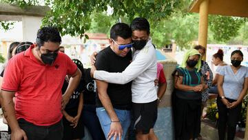 Relatives stand near the coffin of journalist Sheila Garcia, who was shot dead along with another journalist by unidentified gunmen in the municipality of Cosoleacaque.