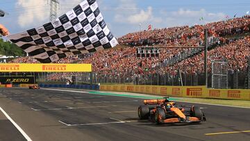 McLaren's Australian driver Oscar Piastri takes the chequered flag of the Formula One Hungarian Grand Prix at the Hungaroring race track in Mogyorod near Budapest on July 21, 2024. (Photo by MARTIN DIVISEK / POOL / AFP)