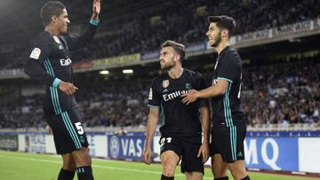 Real Madrid's forward from Spain Borja Mayoral (C) is congratulated by teammates Real Madrid's defender from France Raphael Varane (L) and Real Madrid's midfielder from Spain Marco Asensio after scoring the opening goal during the Spanish l