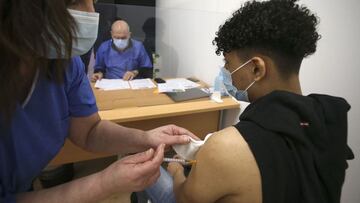 A 18-year-old man receives a dose of the Comirnaty vaccine by Pfizer-BioNTech against Covid-19 at the Baleone vaccine center in Ajaccio on the French Mediterranean island of Corsica, on May 13, 2021. - Vaccination is opened for people over 18 years old since early May in Corsica. The island has the highest vaccination rate in France. (Photo by Pascal POCHARD-CASABIANCA / AFP)