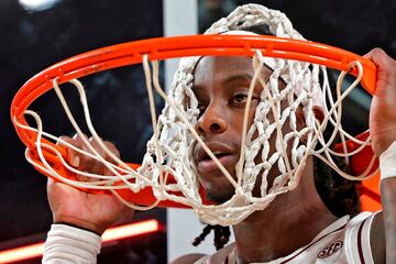 Manny Obaseki, base de la universidad de Texax A&M, se cuelga del aro y pone su cabeza entre la red durante el calentamiento antes del partido contra Wake Forest. Lo cierto es que no tuvo mucha suerte, porque acab¨® con 0 puntos despu¨¦s de fallar los 6 lanzamientos que intent¨®. El consuelo para ¨¦l fue que su equipo se impuso por 44-57.