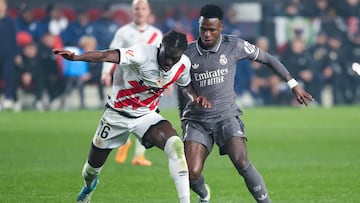 Real Madrid's Brazilian forward #07 Vinicius Junior fights for the ball with Rayo Vallecano's Ghanaian defender #16 Abdul Mumin during the Spanish league football match between Rayo Vallecano de Madrid and Real Madrid CF at the Vallecas stadium in Madrid on December 14, 2024. (Photo by Pierre-Philippe MARCOU / AFP)