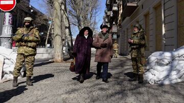 People walk by members of the Ukrainian forces in the central part of Odessa, amid Russia's invasion of Ukraine, in Odessa, Ukraine, March 12, 2022. REUTERS/Igor Tkachenko