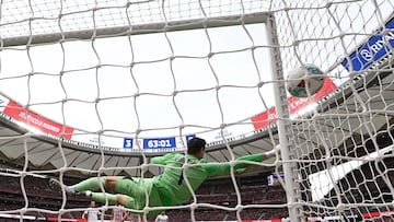 Atletico Madrid's Argentine forward #19 Julian Alvarez scores his team's third goal from the penalty spot in spite of Real Madrid's Belgian goalkeeper #01 Thibaut Courtois during the Spanish league football match between Club Atletico de Madrid and Real Madrid CF at the Metropolitano stadium in Madrid on September 27, 2025. (Photo by OSCAR DEL POZO / AFP)