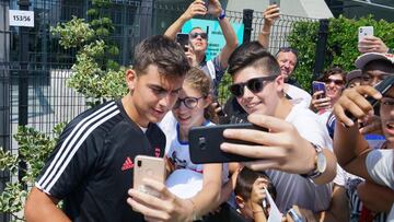 Juventus&#039; forward Paulo Dybala poses for pictures with fans as he leaves the team medical center, in Turin, Italy, Monday, Aug. 5, 2019 . (Tino Romano/ANSA Via AP)