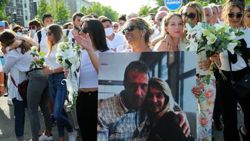 Veronique Monguillot, wife of Philippe Monguillot, a bus driver who was attacked in Bayonne on Sunday night, holds a photo of her with her husband, during a protest march in Bayonne, southwestern France, Wednesday, July 8, 2020.  Monguillot was left brain