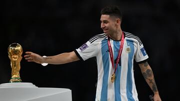 Argentina's defender #04 Gonzalo Montiel touches the FIFA World Cup Trophy during the trophy ceremony after Argentina won the Qatar 2022 World Cup final football match between Argentina and France at Lusail Stadium in Lusail, north of Doha on December 18, 2022. (Photo by Paul ELLIS / AFP)