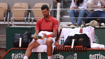 Serbia's Novak Djokovic sits between games during his men's singles round of sixteen match against Argentina's Francisco Cerundolo on Court Philippe-Chatrier on day nine of the French Open tennis tournament at the Roland Garros Complex in Paris on June 3, 2024. (Photo by Emmanuel Dunand / AFP)
