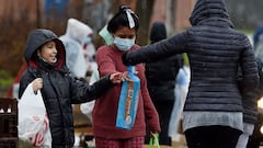 Volunteers from the Baltimore Hunger Project pass out food to people in need. Child tax credit payments pushed by President Joe Biden to alleviate hardship amid the pandemic had an immediate impact in reducing the number of children facing hunger, accordi