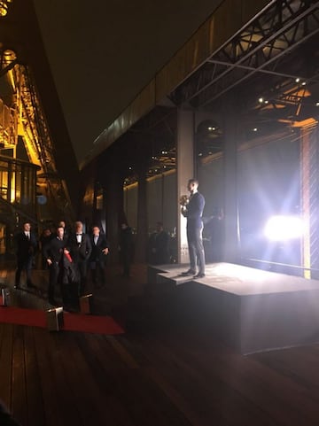 Cristiano Ronaldo makes his entrance at the Ballon d'Or gala holding the award.