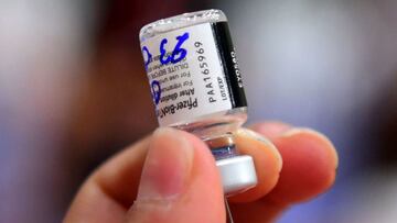 A health worker prepares a dose of the Pfizer-BioNTech vaccine against COVID-19 to inoculate a minor at a vaccination center in Asuncion, on July 23, 2021. - Paraguay started to inoculate children and teenagers from 12 to 17 years-old with underlying dise
