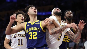 LOS ANGELES, CALIFORNIA - MARCH 16: Trayce Jackson-Davis #32 of the Golden State Warriors pushes Anthony Davis #3 of the Los Angeles Lakers for positoin during the first half of a game at Crypto.com Arena on March 16, 2024 in Los Angeles, California. NOTE TO USER: User expressly acknowledges and agrees that, by downloading and or using this photograph, User is consenting to the terms and conditions of the Getty Images License Agreement.   Sean M. Haffey/Getty Images/AFP (Photo by Sean M. Haffey / GETTY IMAGES NORTH AMERICA / Getty Images via AFP)