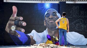 Kobe Bryant, que murió el pasado 26 de enero en un accidente de helicóptero junto a su hija Gigi y otras siete personas, habría cumplido 42 años. Muchos se acordaron de él en esta fecha tan señalada, como se ve en esta imagen, donde un aficionado visita el mural de Melany Meza Después del partido final de los Lakers.