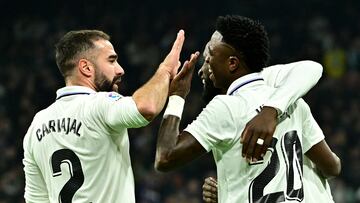 Real Madrid's Brazilian forward Vinicius Junior (R) celebrates scoring his team's second goal with Real Madrid's Spanish defender Dani Carvajal (L) and Real Madrid's German defender Antonio Rudiger during the Spanish league football match between Real Madrid CF and Valencia CF at the Santiago Bernabeu stadium in Madrid on February 2, 2023. (Photo by JAVIER SORIANO / AFP)