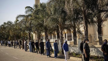 Muslims wearing masks as preventive measure against COVID-19 coronavirus await in line to enter the Nizamiye Mosque ahead of the Friday prayer in Midrand, Johannesburg, on June 5, 2020 as faith activities have resumed in South Africa since June 1 with the