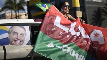 BRASILIA, BRAZIL - OCTOBER 1 : A supporter of Brazil's former President and presidential candidate Luiz Inacio Lula da Silva holds a flag during a motorcade to support local candidate in Brasilia, Brazil October 1, 2022. Around 156 million Brazilians will head to the polls Sunday to cast their ballots for the next president in a country where voting is compulsory. A number of key positions are in contention as 11 candidates vie to become Brazil's next leader. (Photo by Mateus Bonomi/Anadolu Agency via Getty Images)