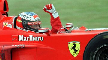 BAS09:SPORT-MOTOR RACING-PRIX:BUENOS AIRES,12APR98 - German Formula One driver of Ferrari, Michael Schumacher, rises his fist in celebration, after winning the Argentine Grand Prix April 12. Finnish Mika Hakkinen, from McLaren, came in second and Britain's Eddie Irvine was third. rr/Photo by Enrique Marcarian REUTERS