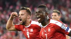 Switzerland&#039;s forward Breel Embolo (R) celebrates his team&#039;s first goal with teammate forward Haris Seferovic during the World Cup 2018 football qualifier between Switzerland and Portugal at the St. Jakob-Park stadium in Basel on September 6, 20