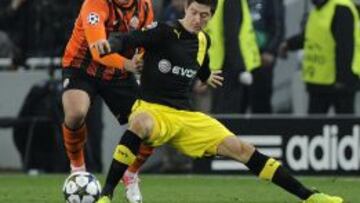 El jugador del Dortmund Robert Lewandowski disputa un balón con Yaroslav Rakitskiy del Shakhtar Donetsk hoy, miércoles 13 de febrero de 2013, durante un partido de la Liga de Campeones en el Donbass Arena en Donetsk (Ucrania).