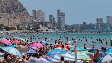 ALICANTE, SPAIN - 2024/07/14: Tourists and locals cool off swimming and sunbathing at a crowded El Postiguet Beach during a summer day. The Tourism Ministry has predicted that 41 million international tourists are expected to visit Spain this summer setting a new record. (Photo by Marcos del Mazo/LightRocket via Getty Images)