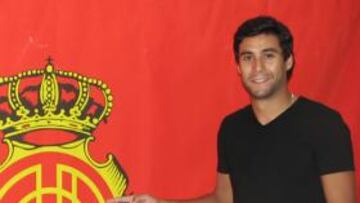 <b>EL TERCERO. </b>El lateral uruguayo Pablo Cáceres, posando ayer con el escudo del Mallorca.